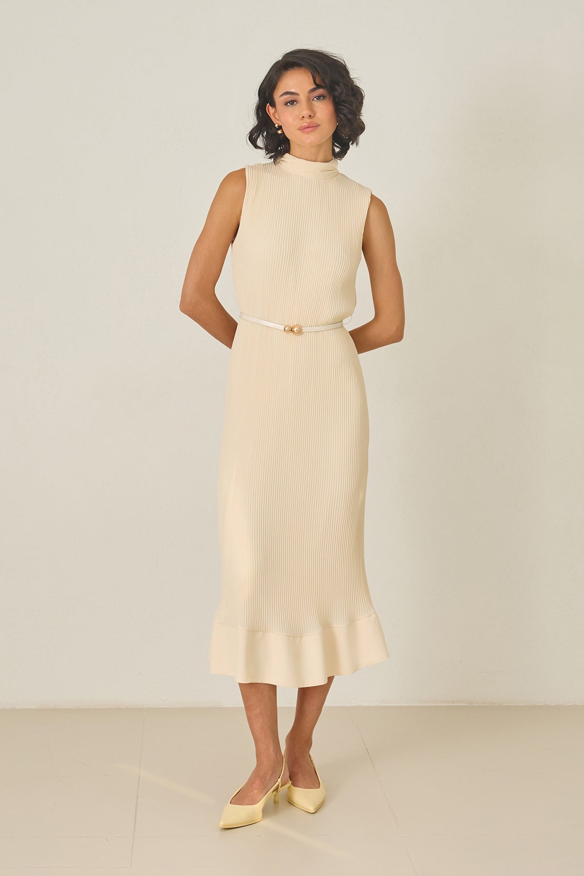 Butter yellow pleated midi dress with high neckline – sleeveless, thin belt, and ruffled hem