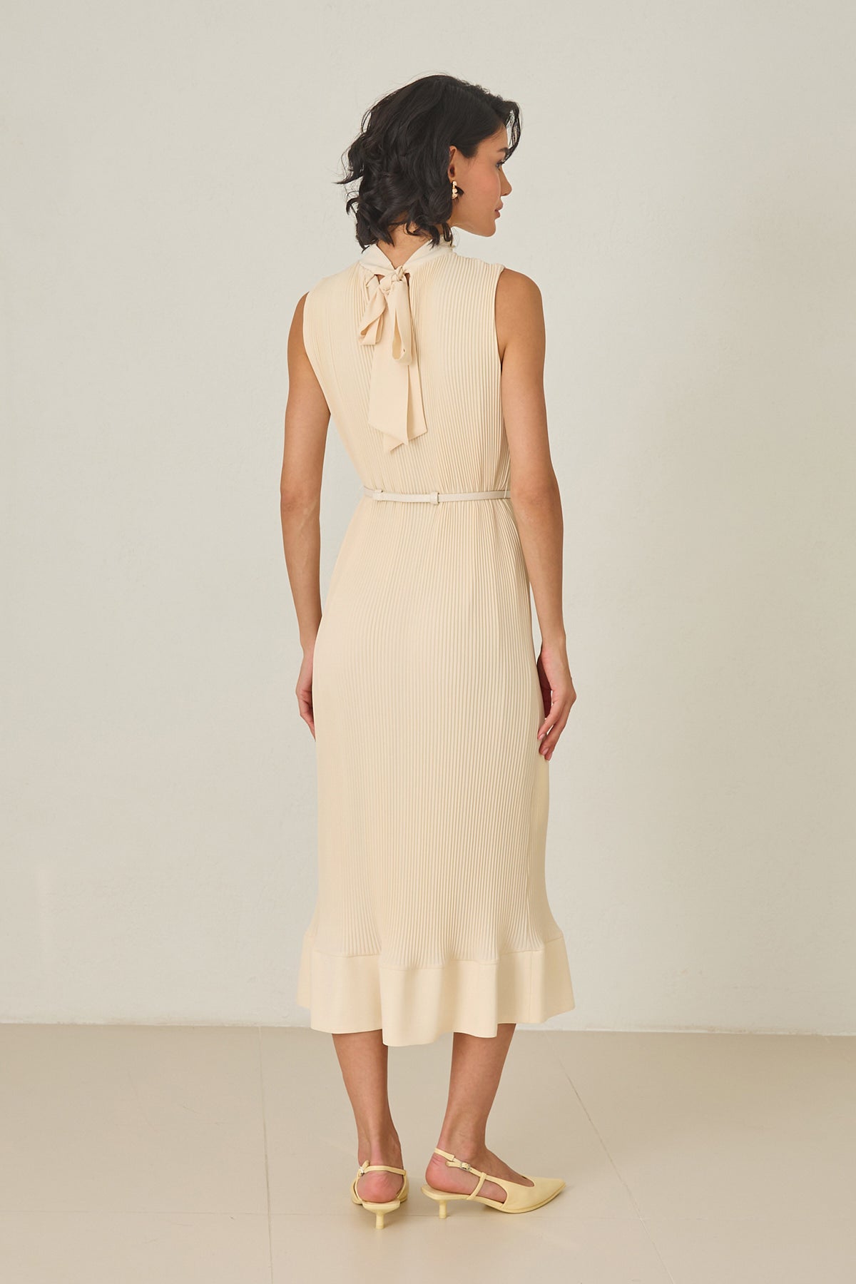 Butter yellow pleated midi dress with high neckline – sleeveless, thin belt, and ruffled hem